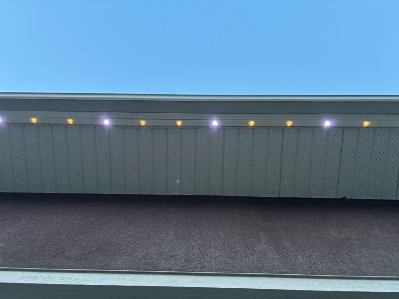 Close-up of permanent LED lights mounted under the soffit of a Castlegar BC home and lit during the day, showing how discreet the track is